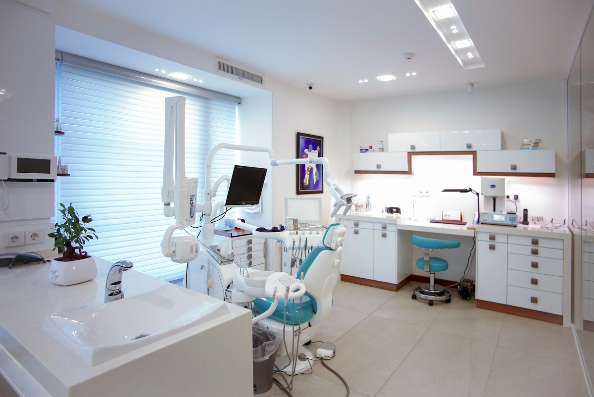 Bright dental treatment room with a chair and equipment