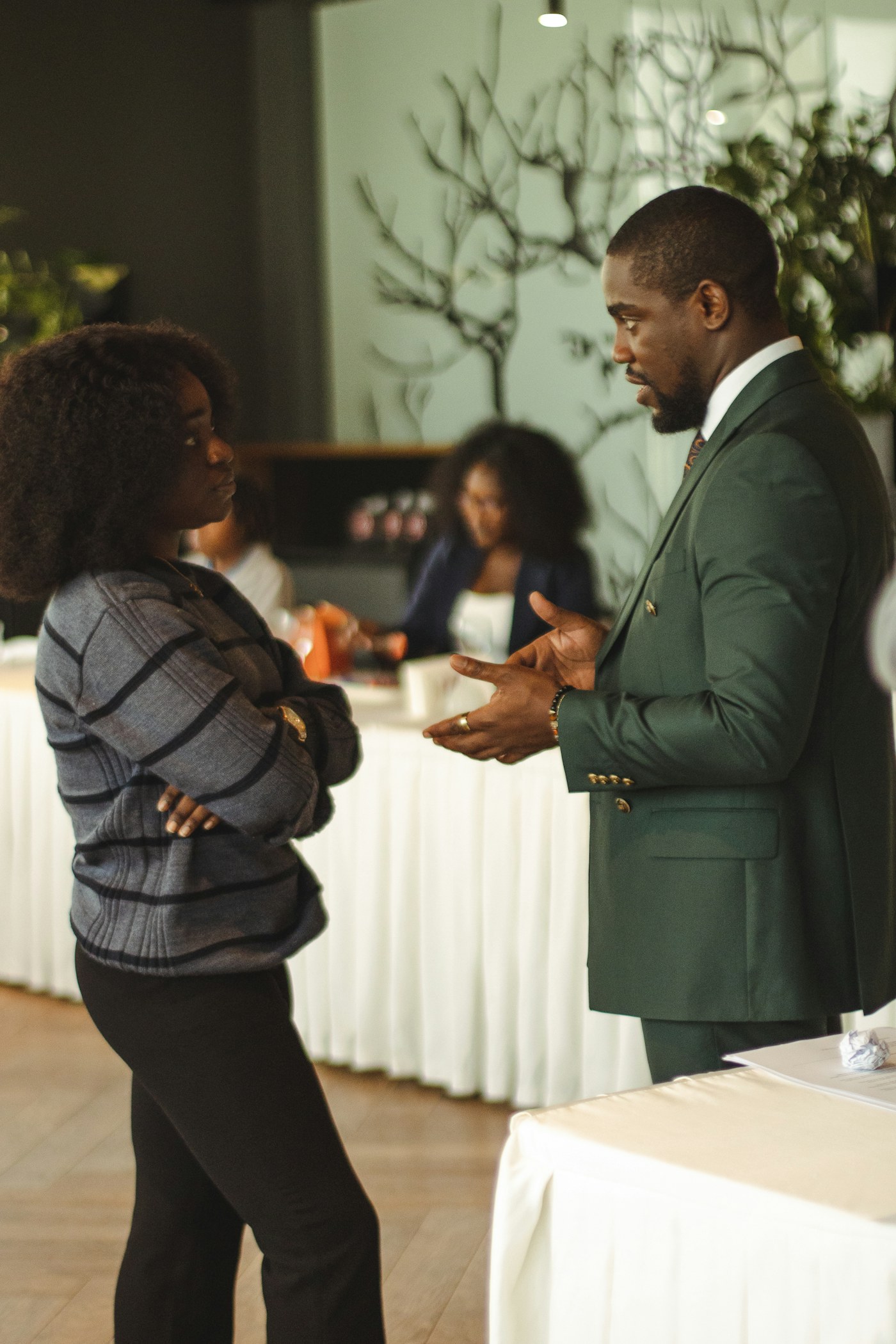 Two professionals having a discussion in a meeting space