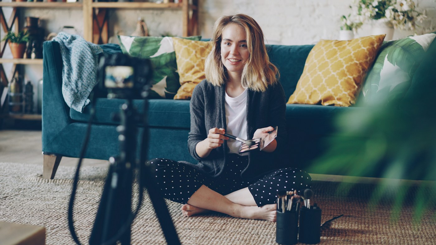A real content creator filming a demonstration with a camera